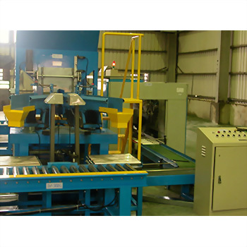 Auto Weighing Packing System - A complex blue and yellow industrial manufacturing machine with conveyor belts and a control panel is set within a factory.